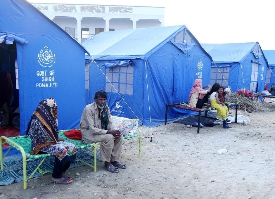 Flood-affected people are seen on the outskirts of Hyderabad, Pakistan, Sept. 18, 2022. (Str/Xinhua/IANS)